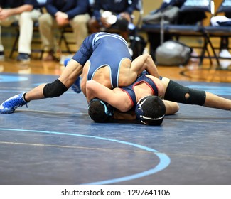 High School Wrestlers Competing At A Wrestling Meet.