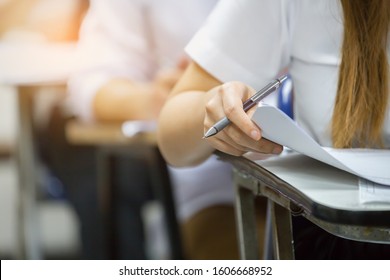 High School,university Student Study.hands Holding Pencil Writing Paper Answer Sheet.sitting Lecture Chair Taking Final Exam Attending In Examination Classroom.concept Scholarship For Education Abroad