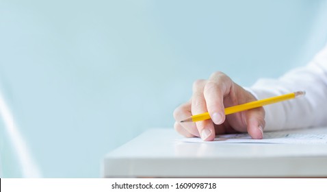 High School,university Student Study.hands Holding Pencil Writing Paper Answer Sheet.sitting Lecture Chair Taking Final Exam Attending In Examination Classroom.concept Scholarship For Education Abroad