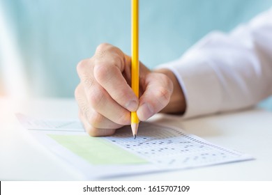 High School,university Student Study.hands Holding Pencil Writing Paper Answer Sheet.sitting Lecture Chair Taking Final Exam Attending In Examination Classroom.concept Scholarship For Education Abroad