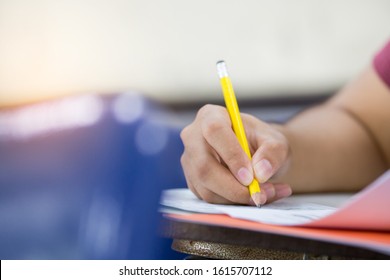 High School,university Student Study.hands Holding Pencil Writing Paper Answer Sheet.sitting Lecture Chair Taking Final Exam Attending In Examination Classroom.concept Scholarship For Education Abroad