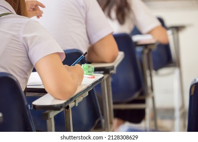 High School,university Student Study.hands Holding Pencil Writing Paper Answer Sheet.sitting Lecture Chair Taking Final Exam Attending In Examination Classroom.concept Scholarship For Education Abroad