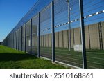 High security fence with spiky Nato wire rolls on top at a German prison in Hanover, Lower Saxony, Germany. Barbed wire to stop prisoners from escaping.