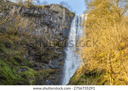 A high shutter speed image of the top section of the Pistyll Rhaeadr waterfall in Wales, UK freezing the water spray droplets