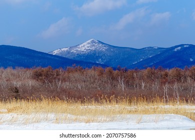 A high snow-capped mountain against the backdrop of a winter field. Sikhote-Alin Biosphere Reserve. - Powered by Shutterstock