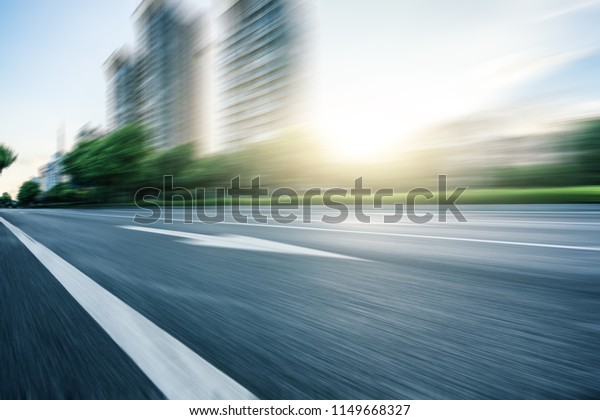 high speed\
asphalt road with city skyline in\
urban