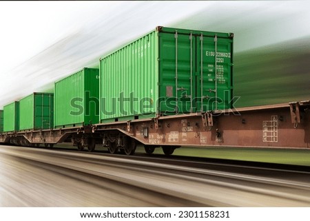 high speed cargo train loaded with ship containers. Heavy motion blur.