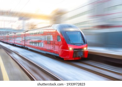High speed double decker express train arrives at a station in the city
