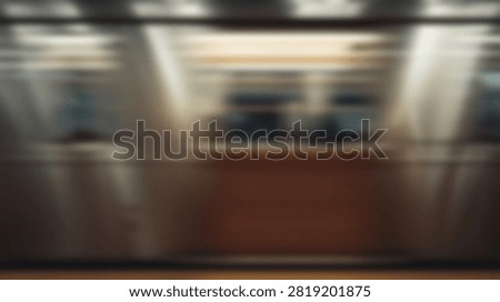 High speed motion blur effect showing a transit train passing through a station interior with abstract light streaks.