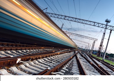 High Speed Passenger Train On Tracks With Motion Blur Effect At Sunset. Railway Station In Ukraine