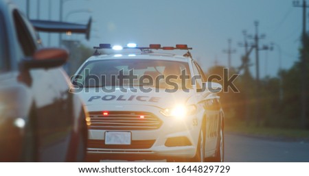 High speed police pursuit on highway. View of cop patrol car chasing a thief on red modern car driving away from the law.