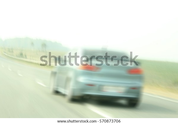 High speed road\
with transportation background. Sport blue car driving at high\
speed in empty road - motion\
blur