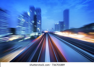 High Speed Train Passing In Between Kuala Lumpur City During Dusk Hour. Focus On The Rail Road.