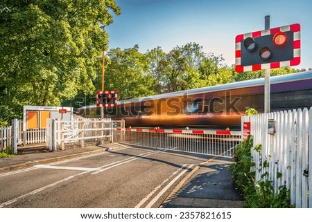 High speed train passing through or over a level crossing on a sunny summer day in England