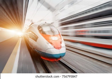 High speed train rides at high speed at the railway station in the city