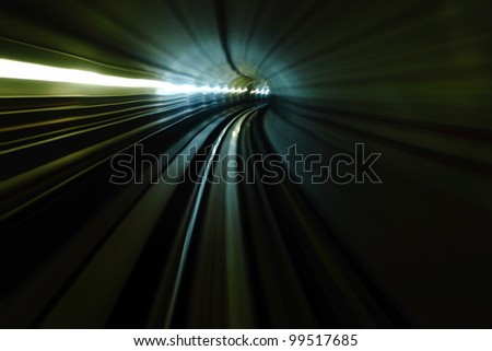 High speed velocity abstract light trail accelerating through a tunnel.