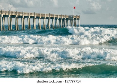 HIgh surf day preceding tropical storm. View of pier and ocean waves in Pensacola, Florida.