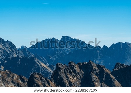 High Tatras mountains scenery with Gerlachovsky stit, Koncista, part of Satansky hreben ridge and few other peaks in Slovakia during beautiful autumn day with clear sky