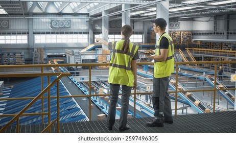 High Tech Autonomous Sortation Fullfilment Center: Two Associate Operative Specialists Optimize Productivity of Package Order Delivery to Customers Worldwide. Modern Logistics, Transportation Facility