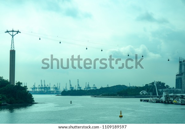 High tech cable cars with accessible pram and\
wheelchair for transportation across the river from city or coast\
land to the opposite island with cloudy and sky background in rainy\
day