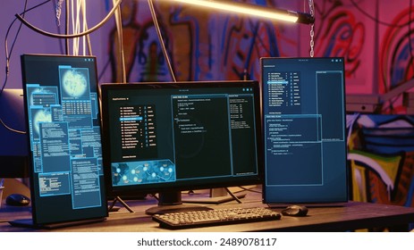 High tech computer systems running malicious code in messy empty criminals hideaway. Virus script running on PC monitors in empty neon lit warehouse used by hackers to commit illegal activities