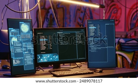 High tech computer systems running malicious code in messy empty criminals hideaway. Virus script running on PC monitors in empty neon lit warehouse used by hackers to commit illegal activities