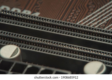 High tech dark background with elements of a computer motherboard in soft focus under high magnification.