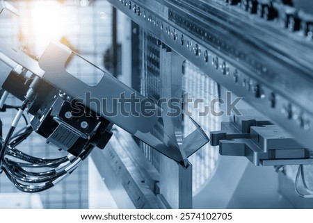 High technology bending machine  operation with robotic system in the light blue scene. The sheet metal working by automatic system.