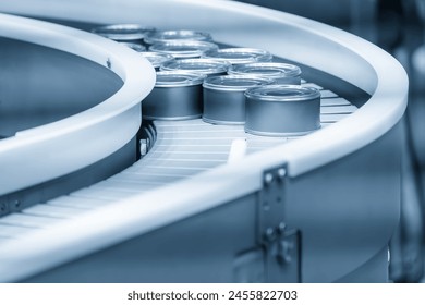 The high technology material handling process in canned food production by roller conveyor. The high technology material handling process by robotic arm.