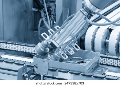 The high technology material handling process in canned food production by robotic system. The high technology material handling process by robotic arm. - Powered by Shutterstock