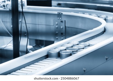 The high technology material handling process in canned food production by roller conveyor. The high technology material handling process by robotic arm.