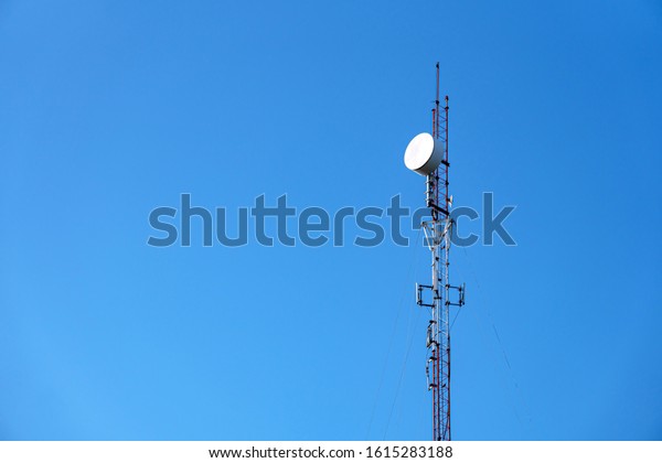 High telephone tower. Beautiful sky with a\
communications tower in the\
foreground