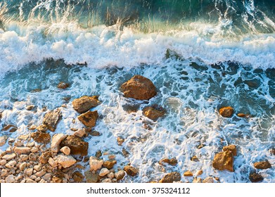 High Tide On A Rocky Beach At Sunset