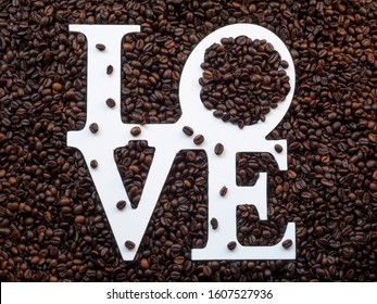 High top view angle of love letters on roasted coffee beans. Concept of coffee lover
