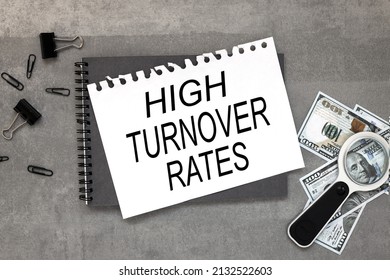 HIGH TURNOVER RATES. gray background text on notepad. magnifying glass paper clip banknotes Flat lay style. Business concept.