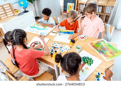 High view over group of different ethnic children enjoy to draw and paint the picture in the classroom in the concept of good activity to generate better creation for kids. - Powered by Shutterstock - Get 15% off with code: PIKWIZARD15