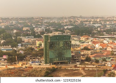 High View Point Cityscape Of Accra, Ghana. Construction Site Of A New Office Building In The Center Of An Accra Neighborhood With Living Houses,  Wastelands  And A Hazy Horizon