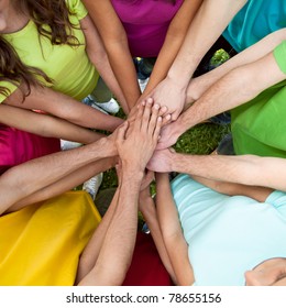 High view of team of friends showing unity with their hands together