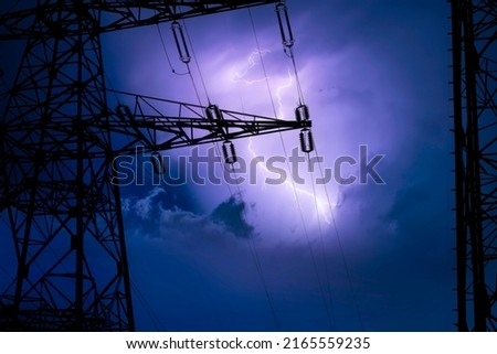 High voltage cable tower in a lightning storm