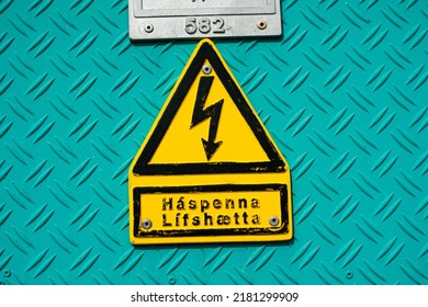 High Voltage Danger Sign Symbol On Industrial Cyan Metal Close-up Shot