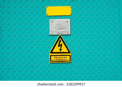 High Voltage Danger Sign Symbol On Industrial Cyan Metal Wall