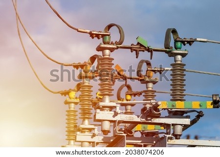 High voltage electric generator insulators.Detail of high voltage circuit breaker in a power substation.high voltage circuit breaker in a power substation on a summer evening.Closeup.