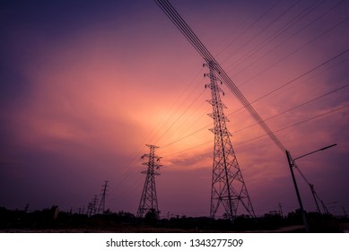 High voltage electric pole on sunset background