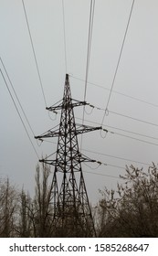 High Voltage Electric Tower Against Grey Smoggy Sky