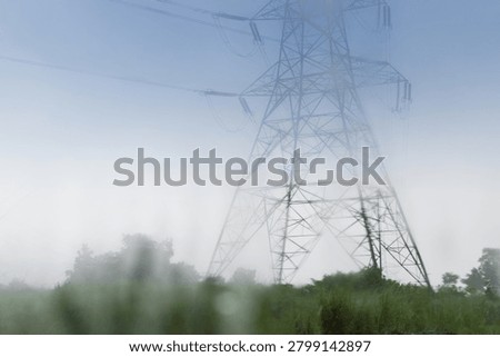 High voltage Electrical power lines supplying electricity to Purulia, West Bengal, India. Abstract image of monsoon, shot through wet glass. Nature image of rainy day at Purulia, West Bengal, India.