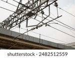 High voltage electrical wires over train tracks. High voltage tower and railway. Train tracks and high voltage cable towers.