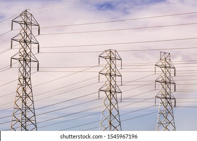 High Voltage Electricity Power Lines And Transmission Towers; Smoke Plume From The Kincaid Wildfire, Burning In Sonoma County, Northern California