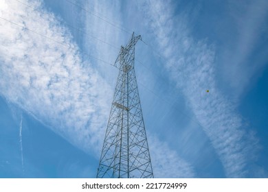 High Voltage Electricity Tower And Power Lines Against Blue Sky In Austin Texas. Looking Up At Tall Grid Towers That Distribute Electrical Energy To Neighborhoods Near Lake Austin.