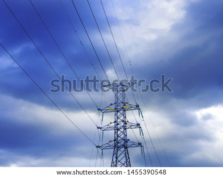 The high voltage electtric pole with a backdrop of blue sky and white cloudy fluff Stock photo © 