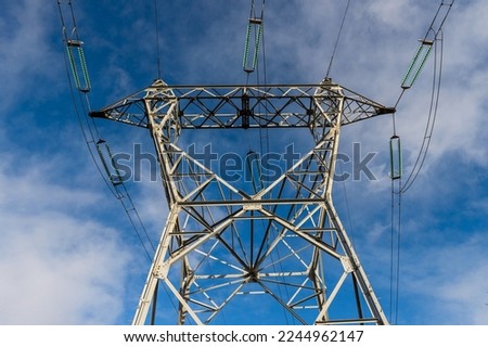 High Voltage (HV) pylon under blue sky near the EDF coal-fired power station at Cordemais (Loire-Atlantique)